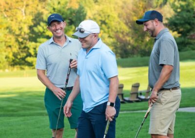 Three golfers enjoying fundraising game on course