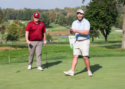Two men on golf course for fundraising event