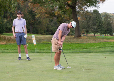 Two young golfers on course playing game