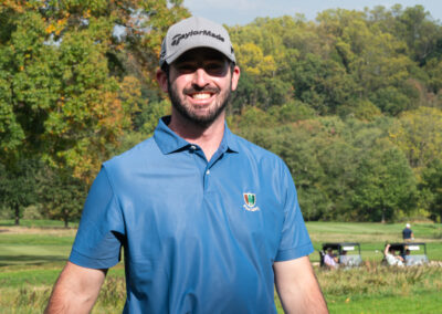 Young golfer in blue shirt happy to participate in game